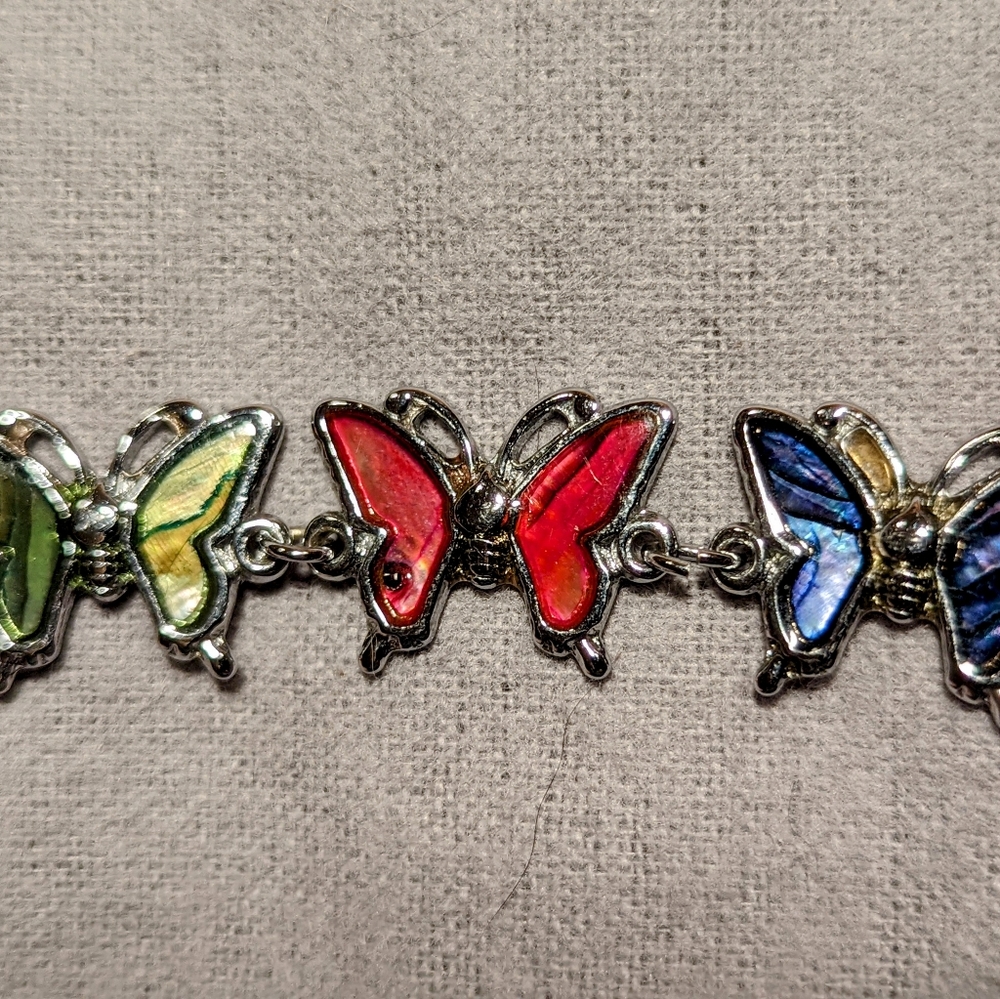 Paua shell butterfly bracelet (7" with 4" extension). Pink, blue, green